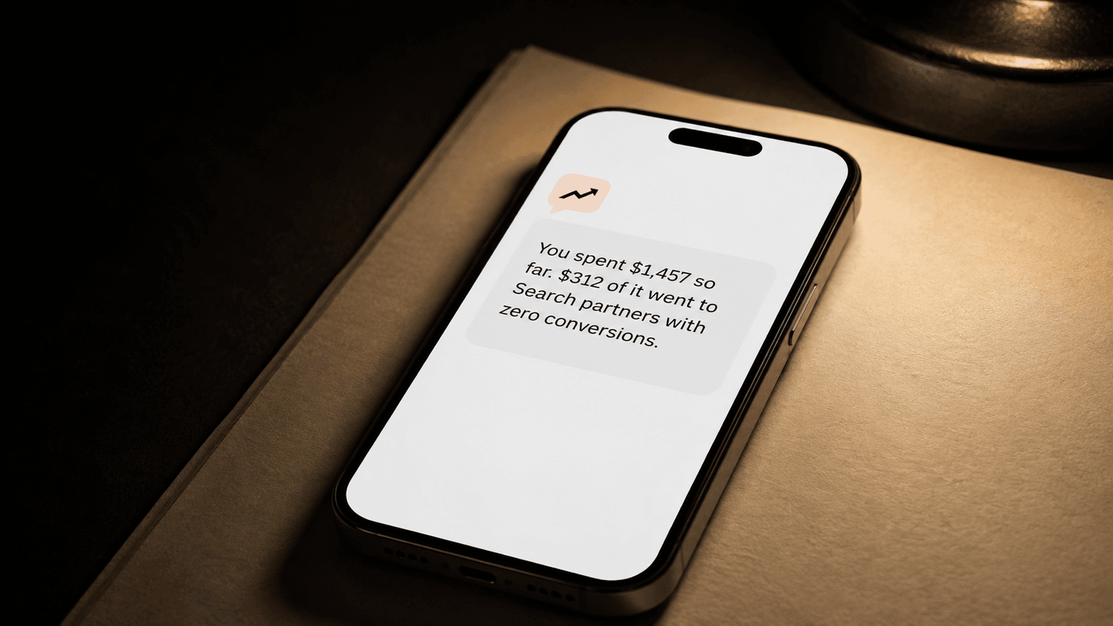 A phone showing an AskMyAds answer about last month's ad spend.